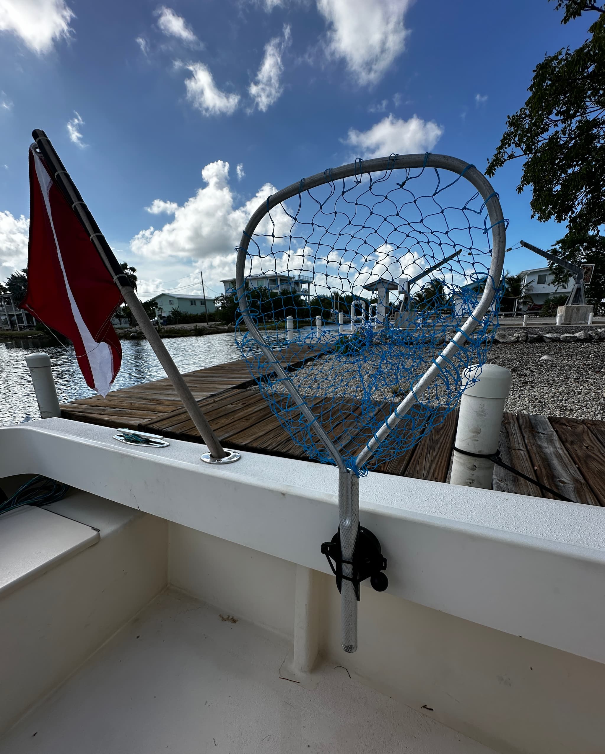 E-Sea Padle & Utility Clip holding a lobster net suction mounted to a boat gunnel