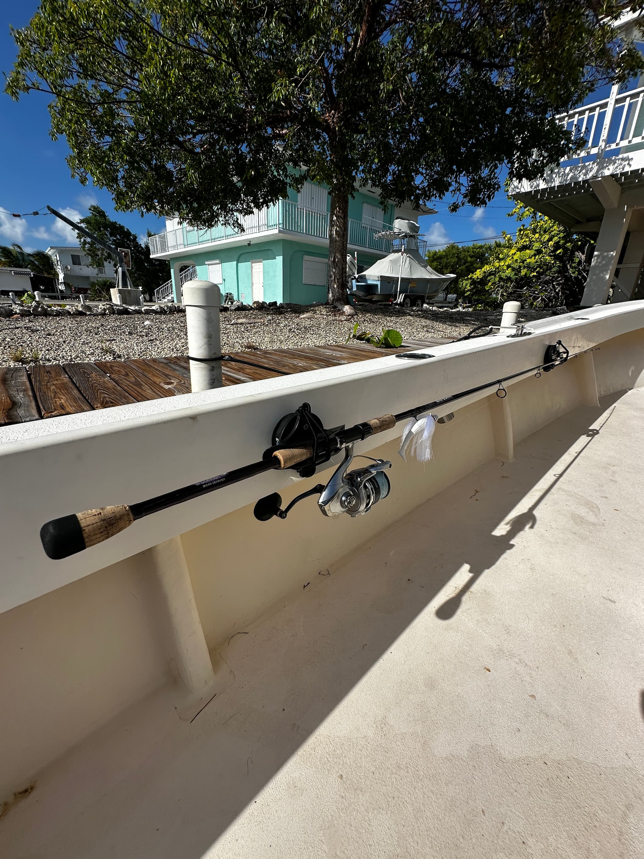 E-Sea Paddle & Utility Clip used as a fishing rod holder on boat gunnel
