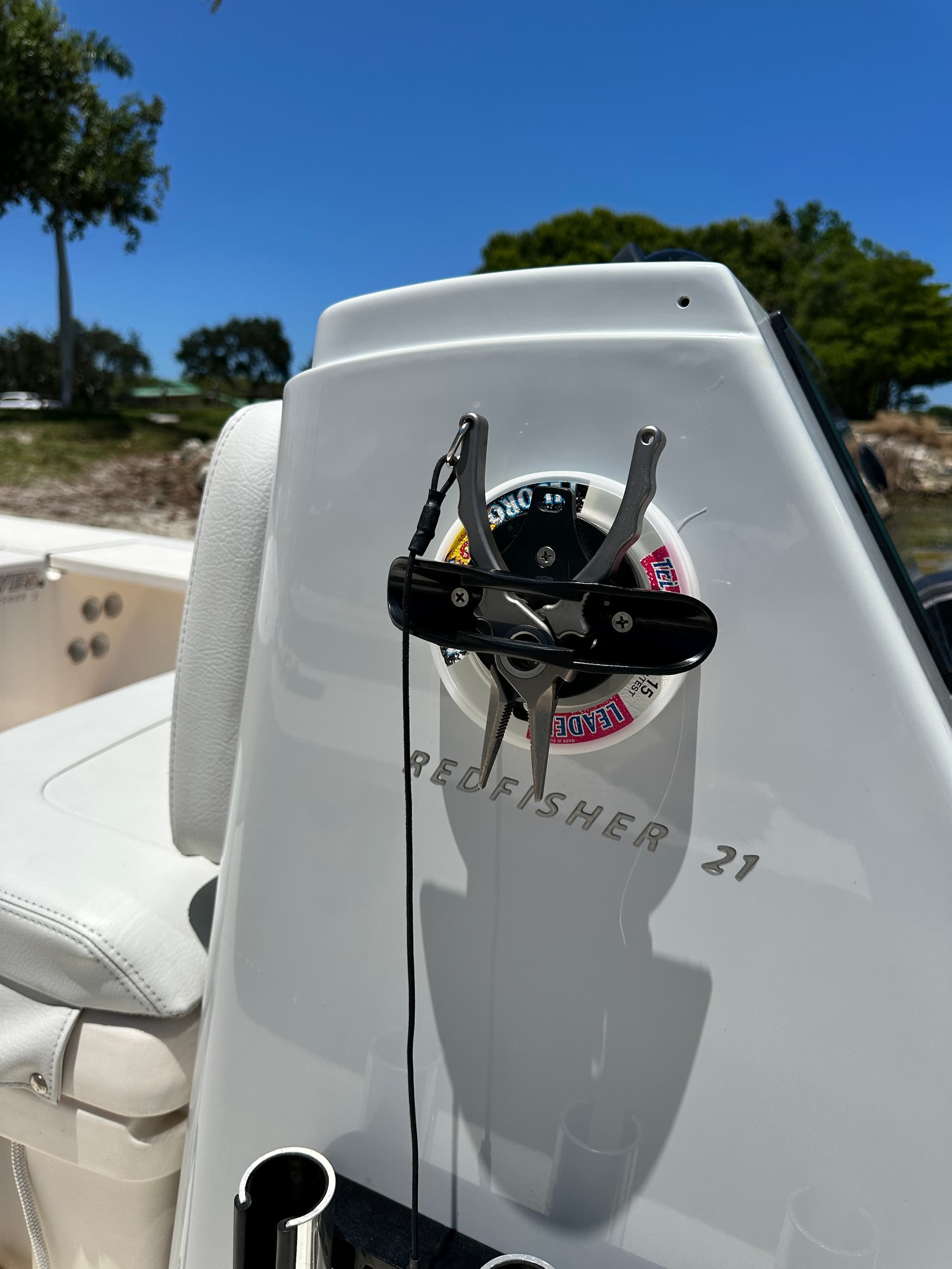 E-Sea Paddle & Utility Clip used as a fishing plyers and leader spool holder on boat console