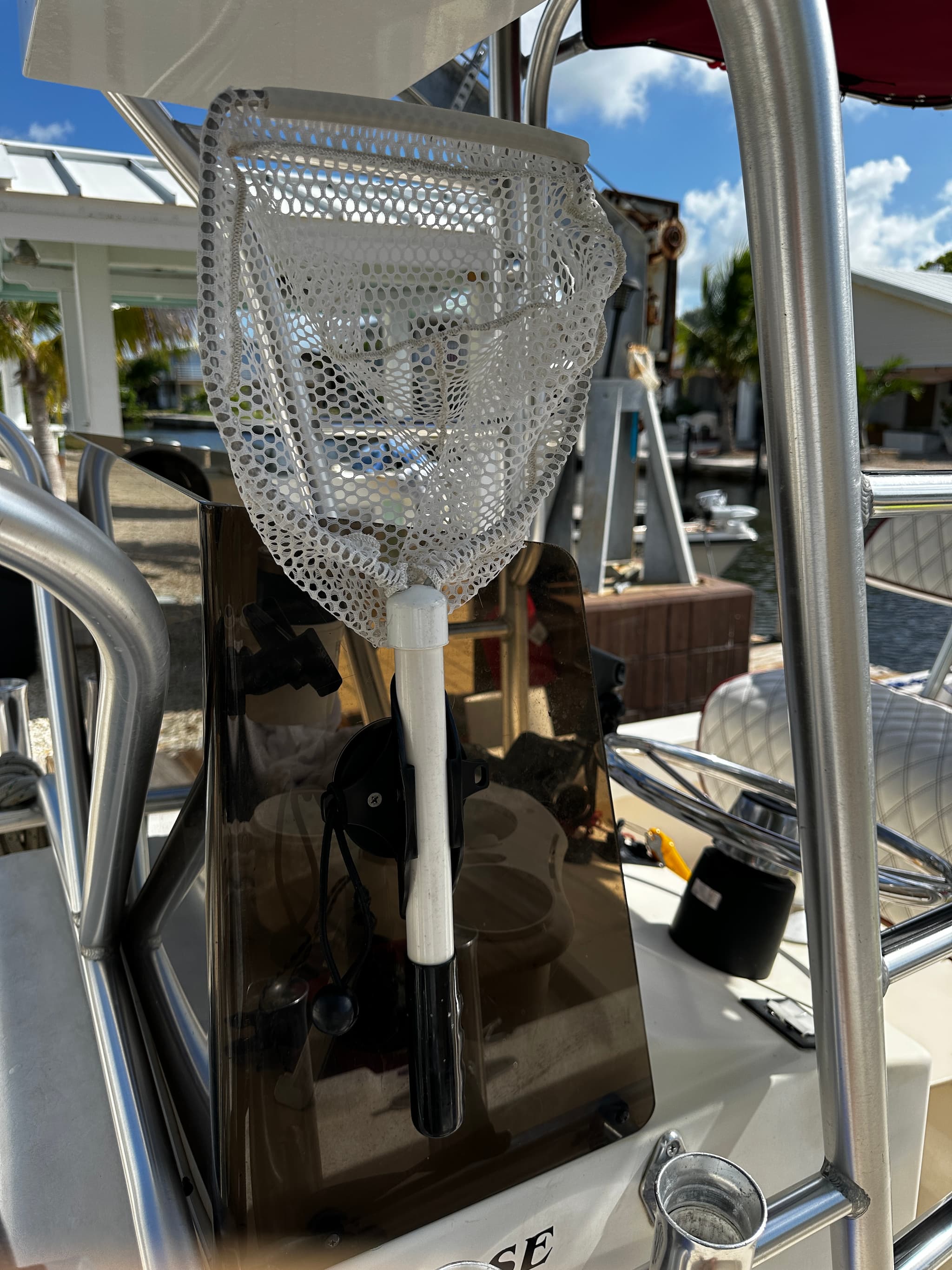 E-Sea Paddle & Utility Clip used as a bait net holder on boat console