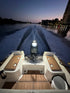 E-Sea Light suction mounted to the top of a boat outboard at dusk lighting up the aft of a boat