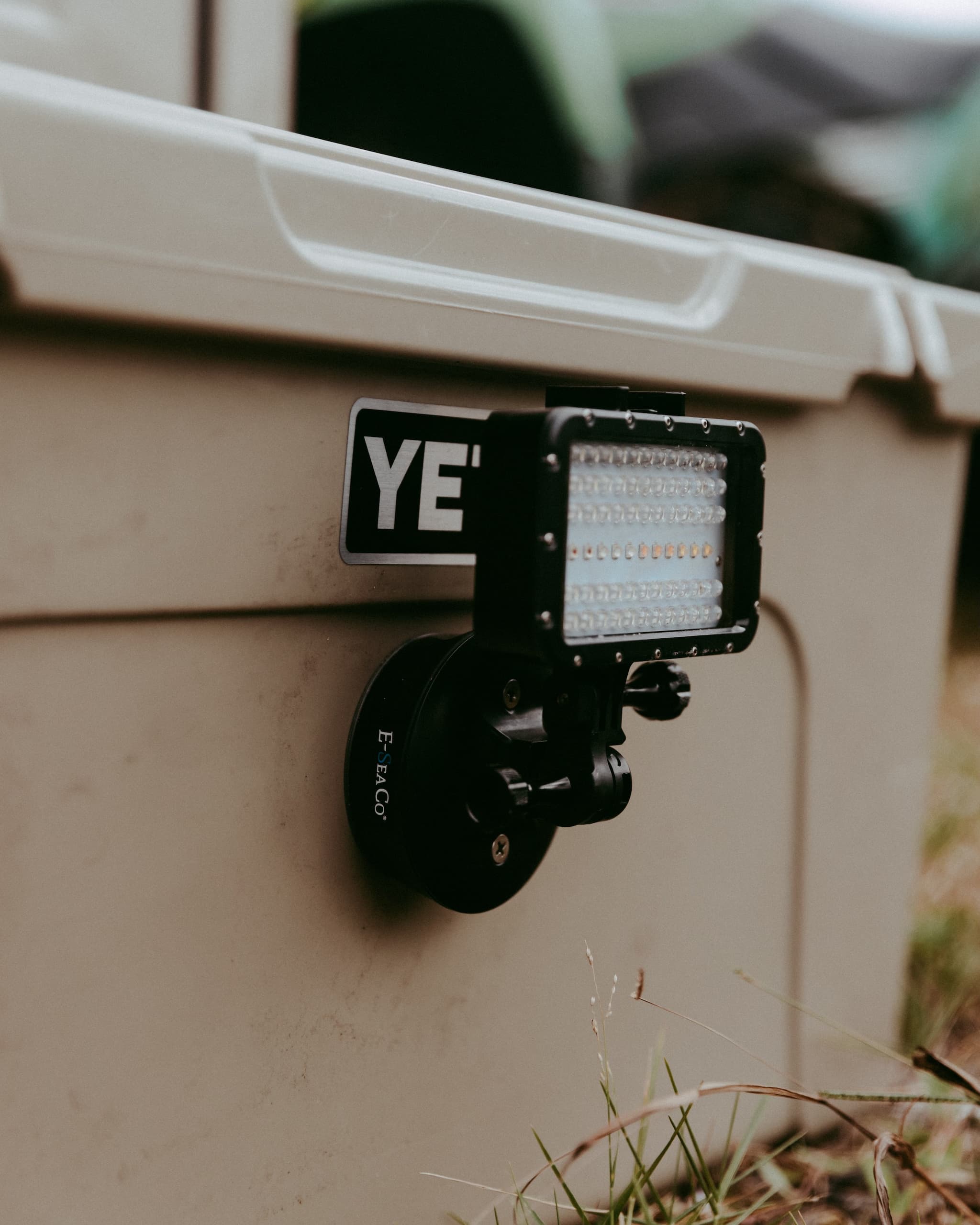 E-Sea Light suction mounted to a tan Yeti Cooler at a campsite